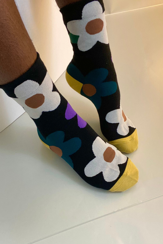 Black daisy crew socks with white, purple, and yellow flowers – bold floral print socks with color block toes