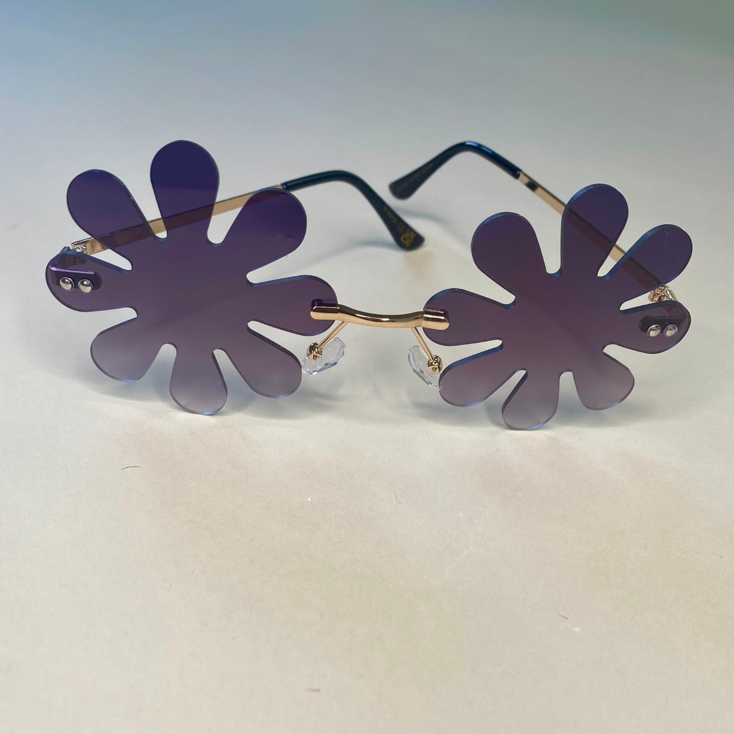 black flower shaped sunglasses with gold arms -retro daisy petal shades