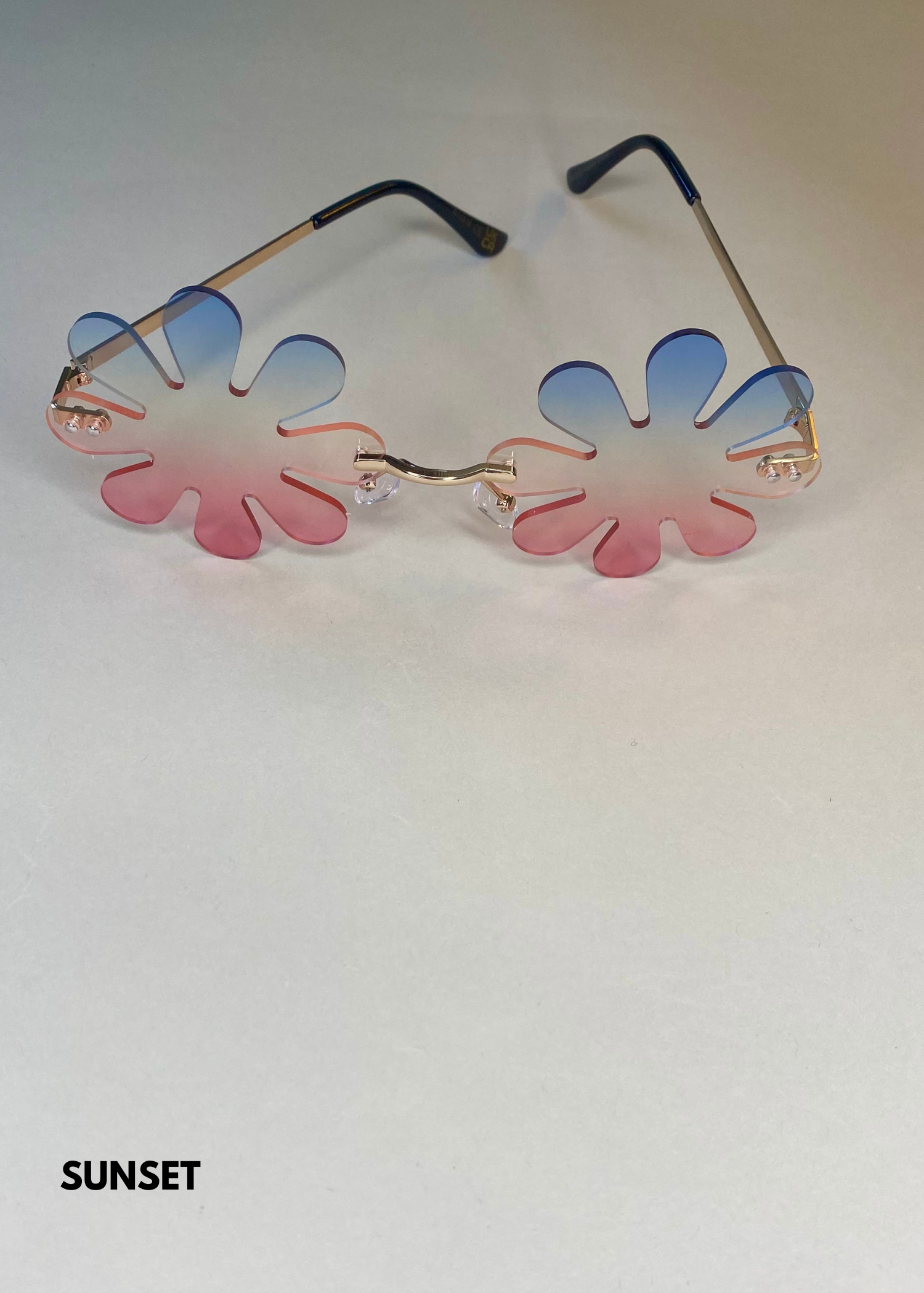 sunset gradient daisy sunglasses in pink and blue - bold flower petal frames with gold accents