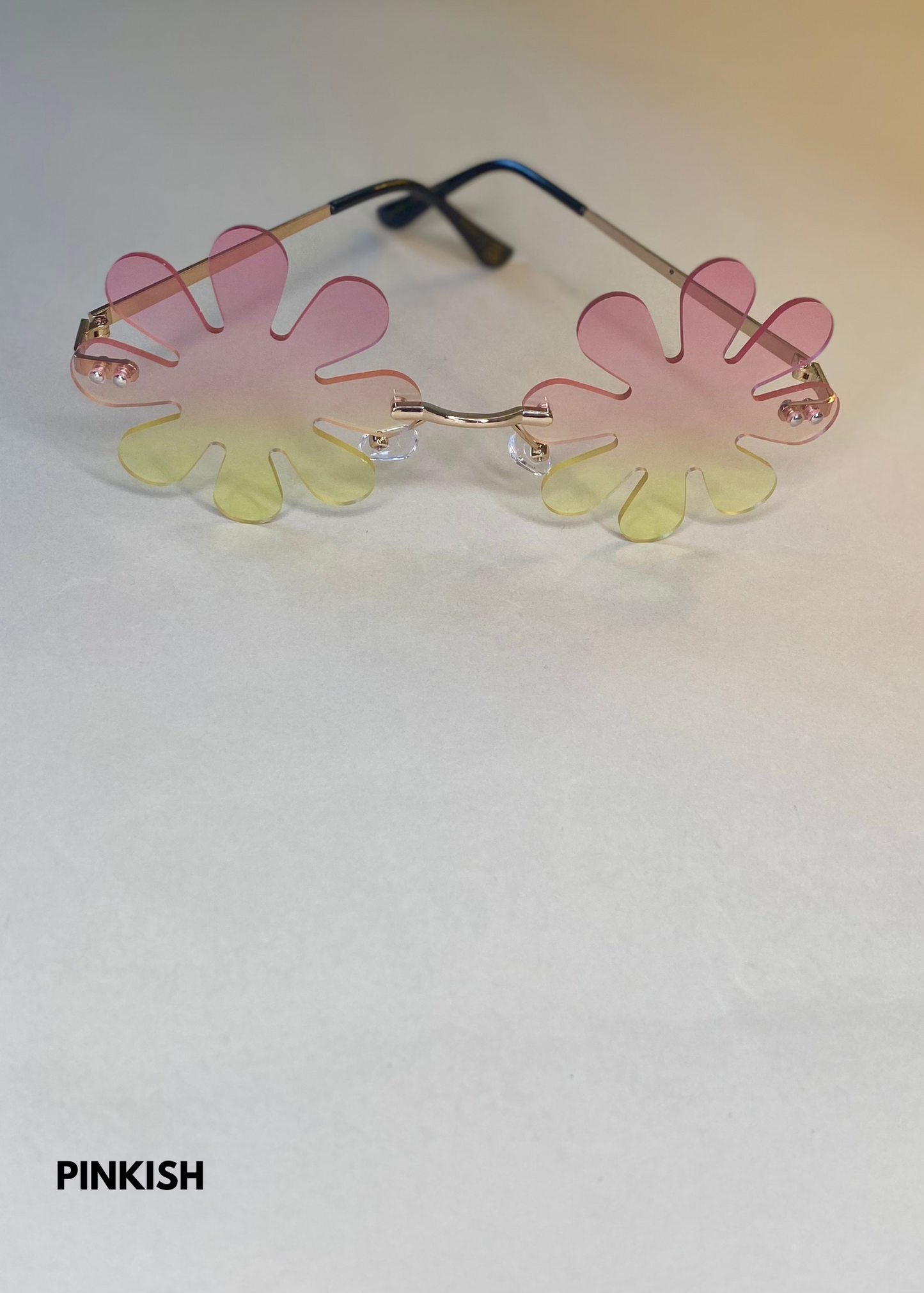 pink gradient splat sunglasses in a daisy flower shape - stylish rimless sunnies with playful petal design and gold temples