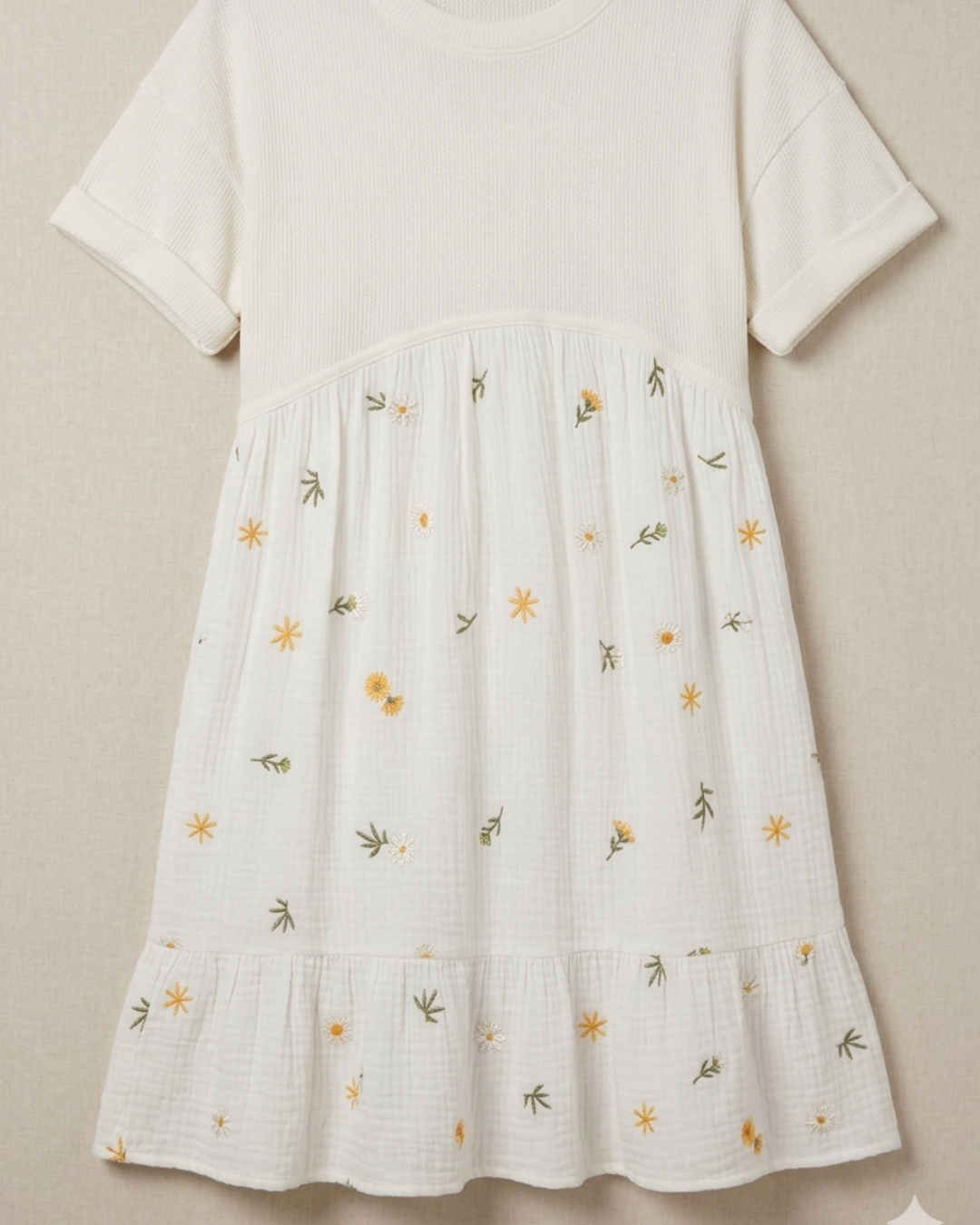 White dress with floral embroidery on a beige background